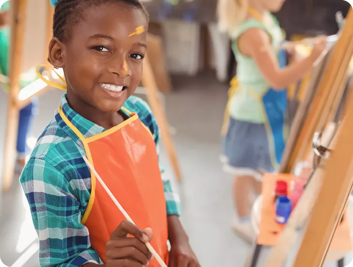 boy painting at easel